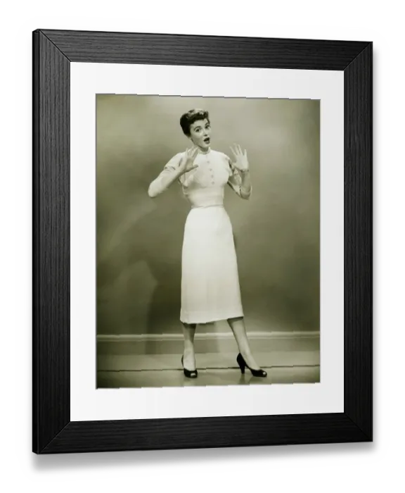 Framed Print : Young woman standing in empty room, gesturing, (B&W) Framed Print : Young woman standing in empty room, gesturing, (B&W)
