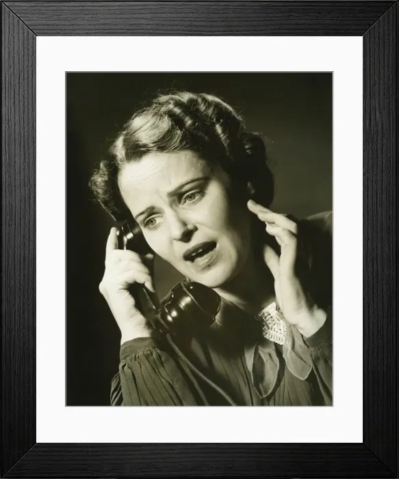 Framed Print : Woman on phone in studio, (B&W), close-up, portrait Framed Print : Woman on phone in studio, (B&W), close-up, portrait