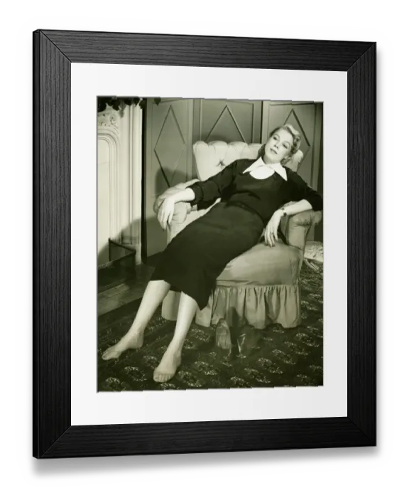 Framed Print : Woman reclining in armchair, (B&W) Framed Print : Woman reclining in armchair, (B&W)