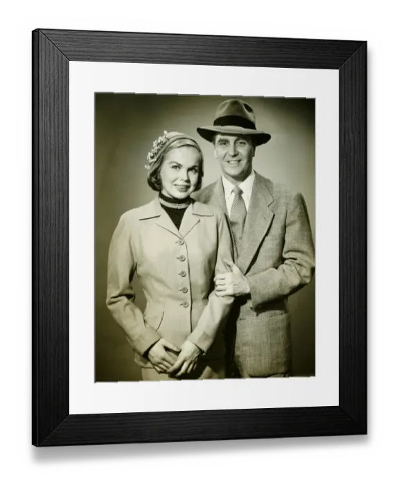 Framed Print : Young couple in studio, man holding woman, smiling, (B&W), portrait Framed Print : Young couple in studio, man holding woman, smiling, (B&W), portrait