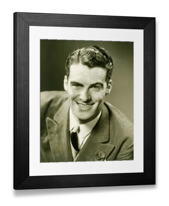 Framed Print : Smiling man posing in studio, (B&W), close-up, portrait