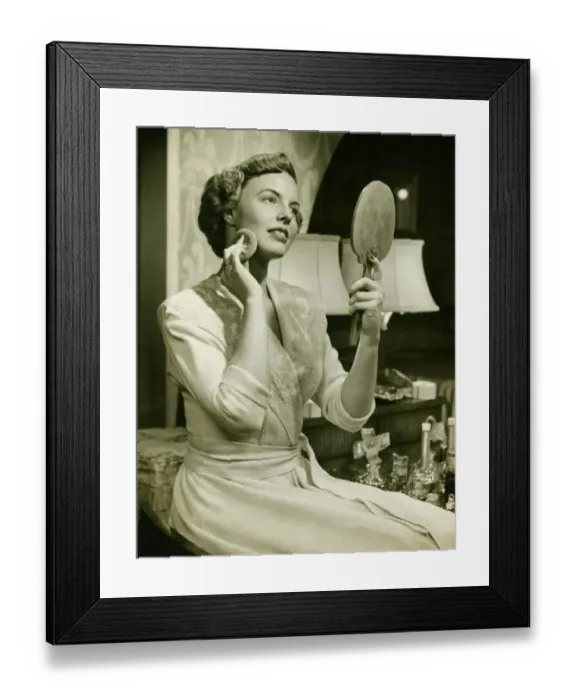 Framed Print : Young woman powdering face, at home, (B&W), close-up Framed Print : Young woman powdering face, at home, (B&W), close-up