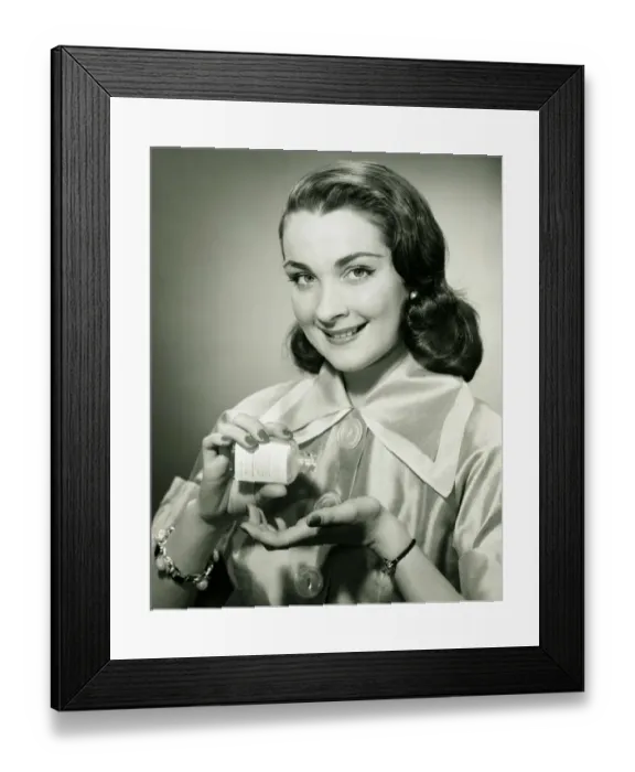 Framed Print : Woman pouring pills from bottle into hand in studio, (B&W), portrait Framed Print : Woman pouring pills from bottle into hand in studio, (B&W), portrait