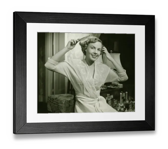 Framed Print : Young woman brushing hair, at home, (B&W), portrait Framed Print : Young woman brushing hair, at home, (B&W), portrait