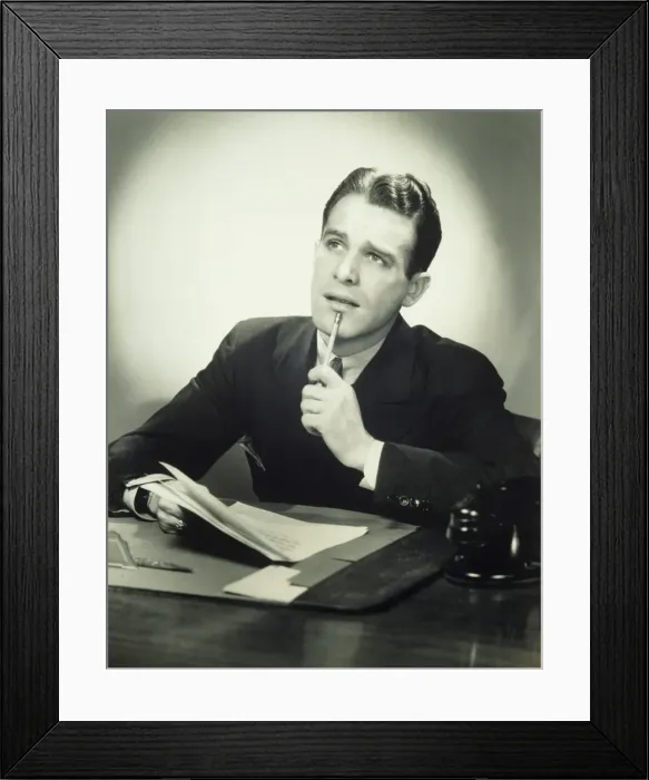 Framed Print : Wondering businessman at desk, (B&W), portrait Framed Print : Wondering businessman at desk, (B&W), portrait