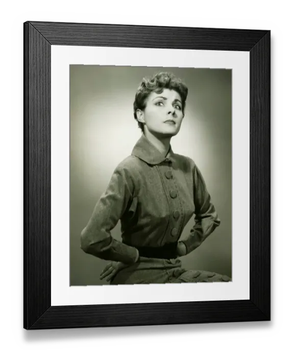 Framed Print : Woman with displeased expression posing in studio, (B&W), portrait Framed Print : Woman with displeased expression posing in studio, (B&W), portrait