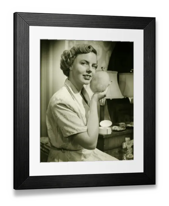 Framed Print : Young woman powdering face, at home, (B&W), portrait Framed Print : Young woman powdering face, at home, (B&W), portrait