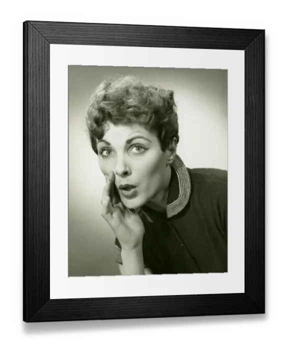 Framed Print : Woman whispering in studio, (B&W), portrait Framed Print : Woman whispering in studio, (B&W), portrait
