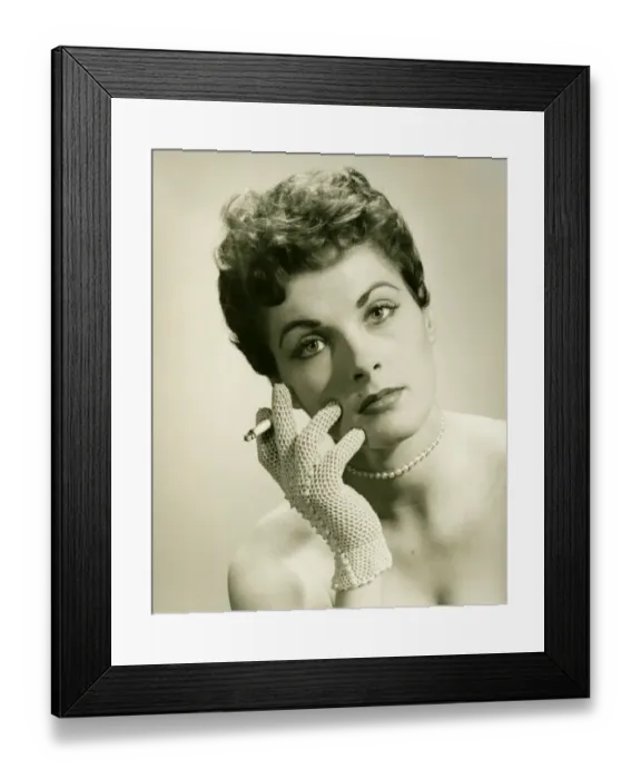 Framed Print : Woman wearing lace glove holding cigarette in studio, (B&W), portrait Framed Print : Woman wearing lace glove holding cigarette in studio, (B&W), portrait