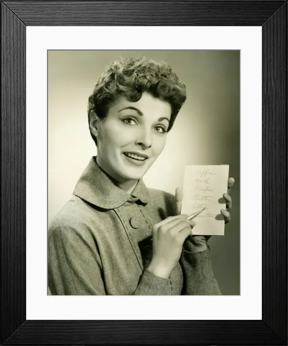 Framed Print : Woman showing shopping list in studio, (B&W), portrait Framed Print : Woman showing shopping list in studio, (B&W), portrait
