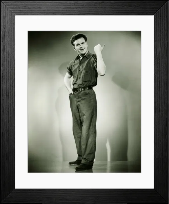 Framed Print : Young man standing in studio, gesturing, (B&W) Framed Print : Young man standing in studio, gesturing, (B&W)