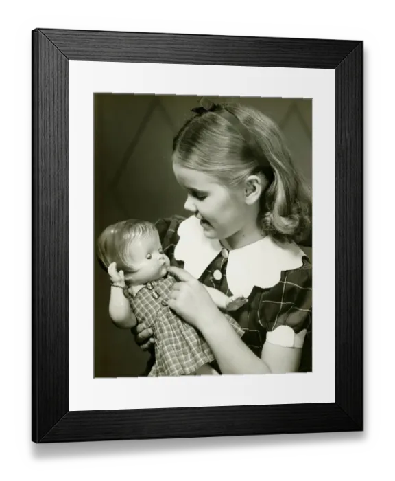 Framed Print : Young girl (10-11) holding doll, (B&W) Framed Print : Young girl (10-11) holding doll, (B&W)