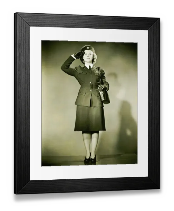 Framed Print : Woman wearing World War II uniform saluting in studio, (B&W), portrait Framed Print : Woman wearing World War II uniform saluting in studio, (B&W), portrait