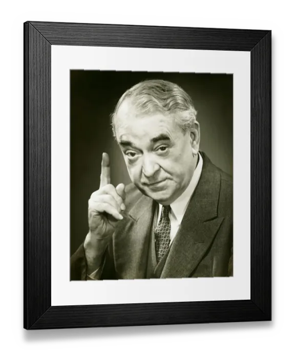 Framed Print : Senior man raising index finger in studio, (B&W), close-up, portrait Framed Print : Senior man raising index finger in studio, (B&W), close-up, portrait