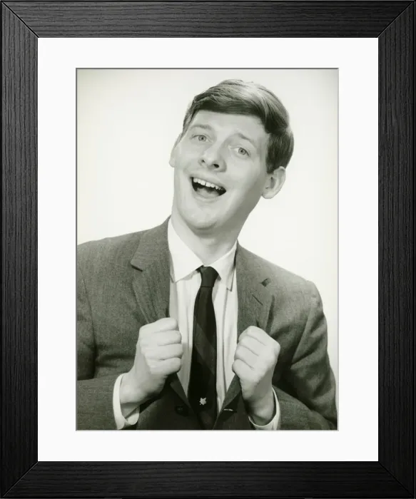 Framed Print : Smiling man with clenched fists in studio, (B&W), portrait Framed Print : Smiling man with clenched fists in studio, (B&W), portrait