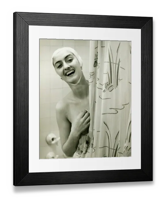 Framed Print : Smiling woman peeping behind shower curtain, (B&W), portrait Framed Print : Smiling woman peeping behind shower curtain, (B&W), portrait