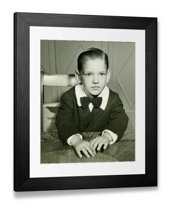 Framed Print : Pensive boy (4-5) posing at table, (B&W), portrait Framed Print : Pensive boy (4-5) posing at table, (B&W), portrait