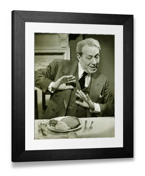 Framed Print : Man refusing to eat dinner in restaurant, (B&W) Framed Print : Man refusing to eat dinner in restaurant, (B&W)