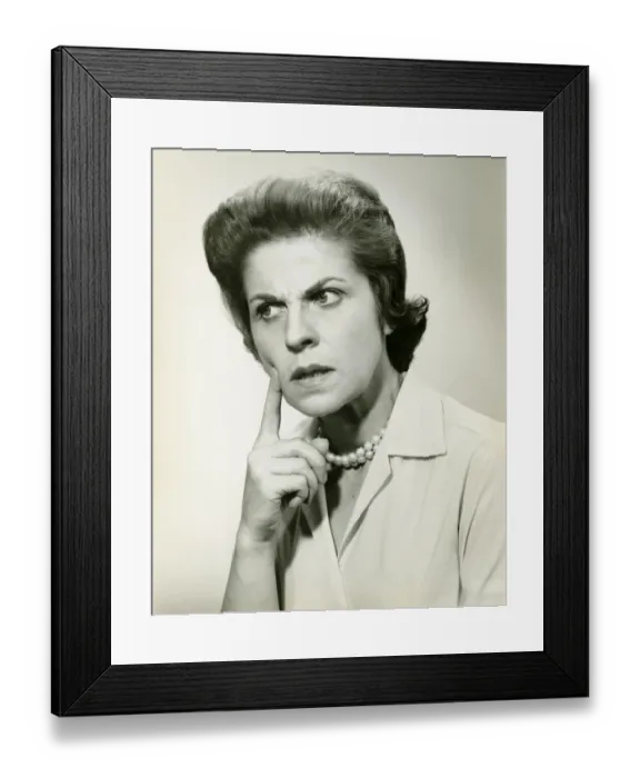 Framed Print : Woman with puzzled expression, in studio, (B&W), portrait Framed Print : Woman with puzzled expression, in studio, (B&W), portrait