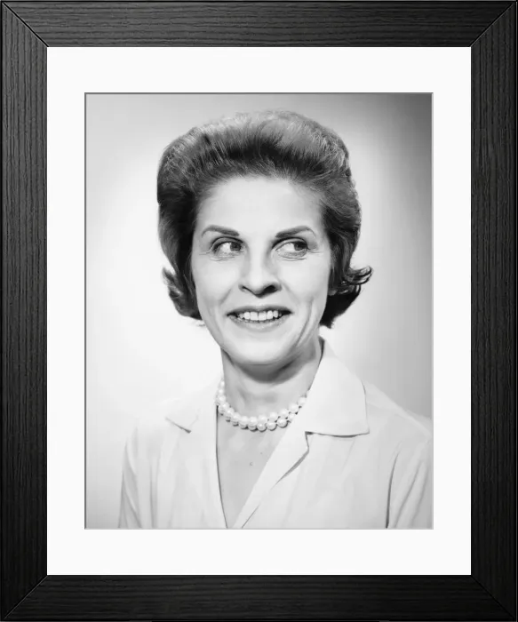 Framed Print : Woman wearing pearls smiling, looking away, posing in studio, (B&W), portrait Framed Print : Woman wearing pearls smiling, looking away, posing in studio, (B&W), portrait