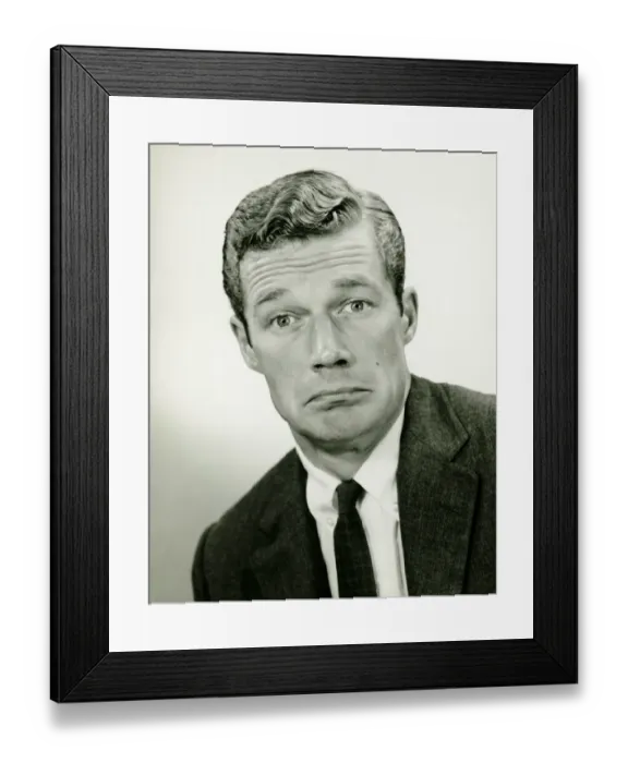 Framed Print : Young businessman looking sad, posing in studio, (B&W), portrait