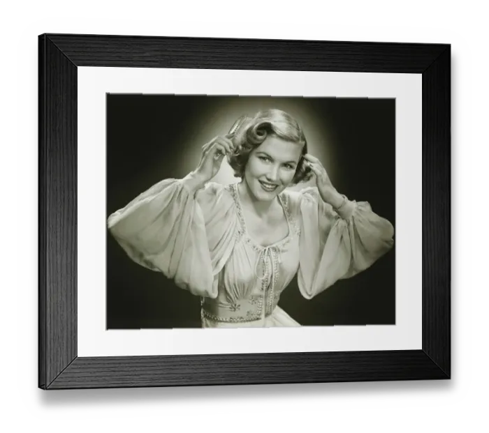 Framed Print : Woman in evening dress brushing hair, (B&W), portrait Framed Print : Woman in evening dress brushing hair, (B&W), portrait