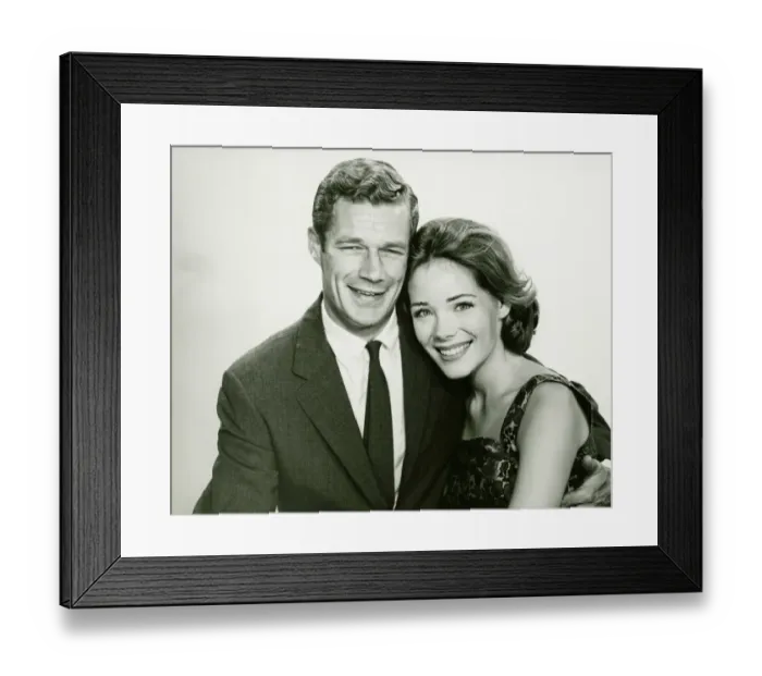 Framed Print : Young couple smiling, posing in studio, (B&W), portrait Framed Print : Young couple smiling, posing in studio, (B&W), portrait