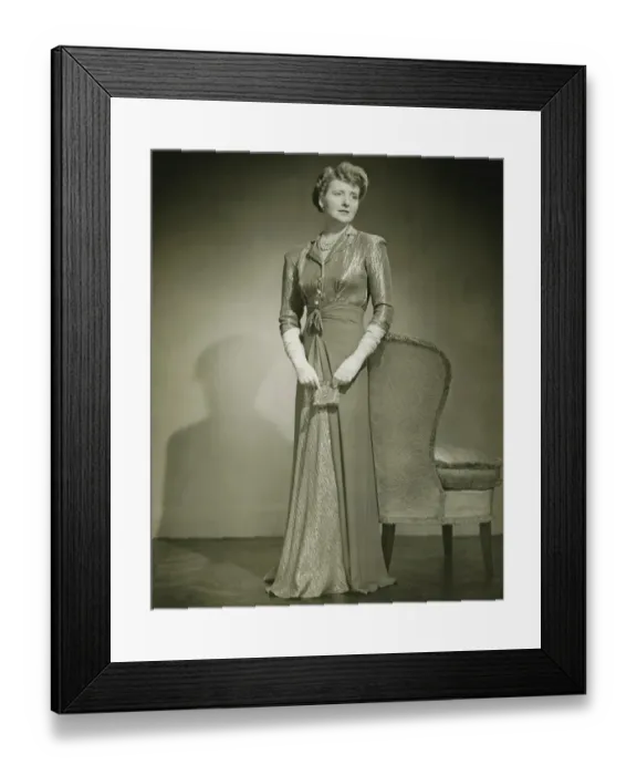Framed Print : Woman in evening dress standing indoors, (B&W) Framed Print : Woman in evening dress standing indoors, (B&W)