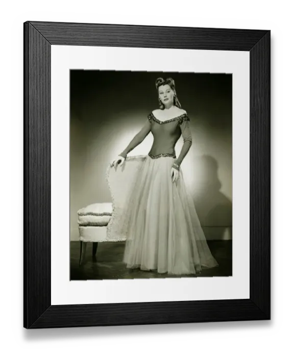 Framed Print : Woman in evening dress standing indoors, (B&W) Framed Print : Woman in evening dress standing indoors, (B&W)