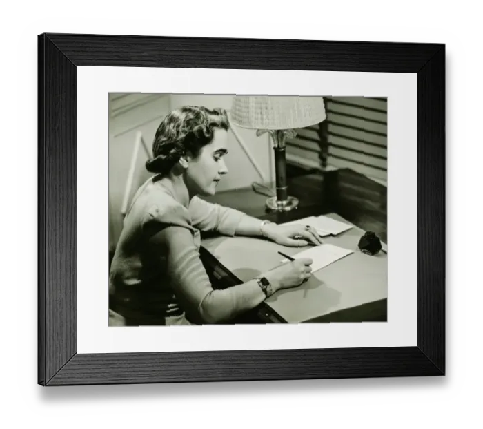 Framed Print : Woman sitting at desk, writing, (B&W) Framed Print : Woman sitting at desk, writing, (B&W)