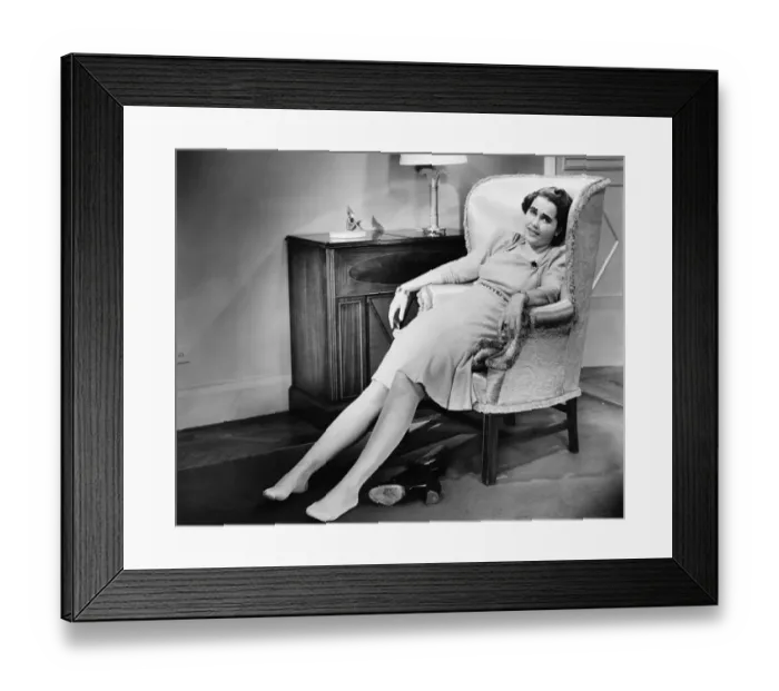 Framed Print : Woman reclining in armchair, exhausted, (B&W) Framed Print : Woman reclining in armchair, exhausted, (B&W)