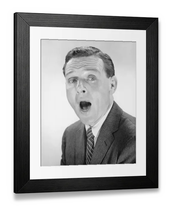 Framed Print : Man yawning, posing in studio, (B&W), portrait Framed Print : Man yawning, posing in studio, (B&W), portrait