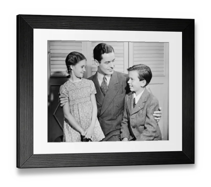 Framed Print : Father with arms around children, boy (10-11) girl (6-7), (B&W) Framed Print : Father with arms around children, boy (10-11) girl (6-7), (B&W)