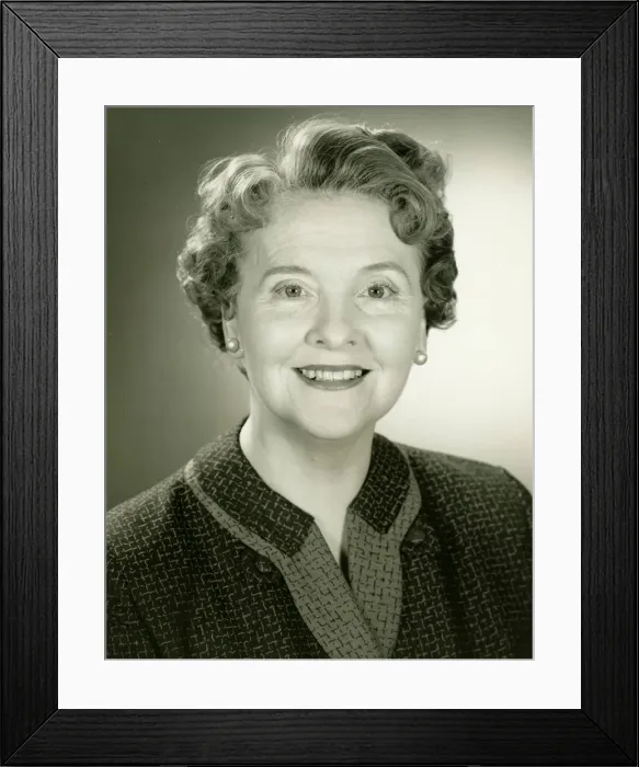 Framed Print : Senior woman smiling in studio, (B&W), close-up, portrait Framed Print : Senior woman smiling in studio, (B&W), close-up, portrait