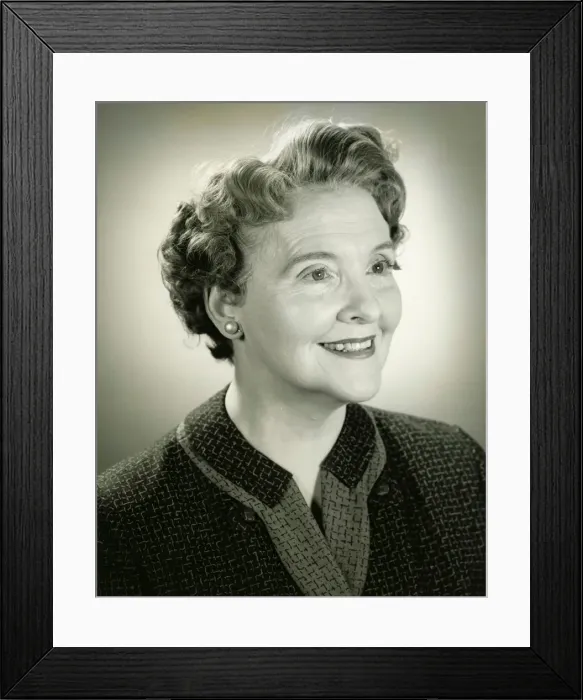 Framed Print : Senior woman smiling in studio, (B&W), close-up, portrait Framed Print : Senior woman smiling in studio, (B&W), close-up, portrait