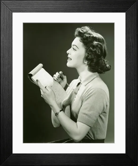 Framed Print : Woman secretary making notes in notebook, (B&W) Framed Print : Woman secretary making notes in notebook, (B&W)
