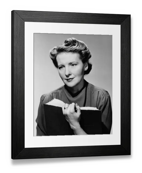 Framed Print : Woman sitting holding book, (B&W), portrait Framed Print : Woman sitting holding book, (B&W), portrait