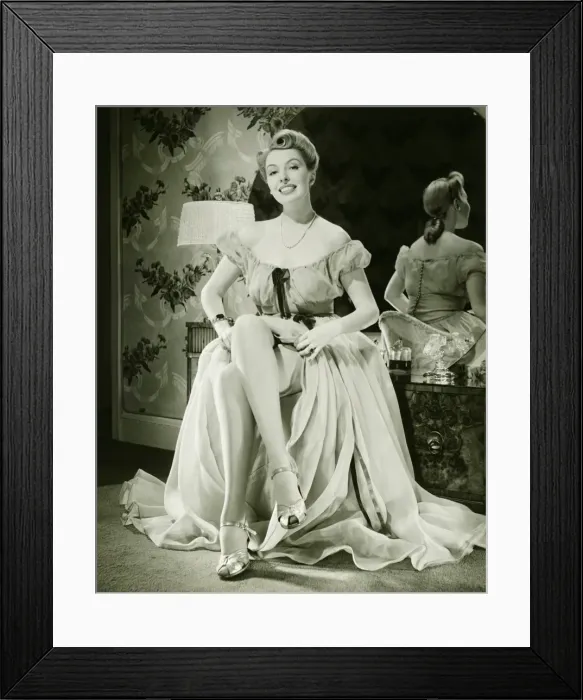 Framed Print : Glamorous woman in evening gown showing legs, (B&W), portrait Framed Print : Glamorous woman in evening gown showing legs, (B&W), portrait