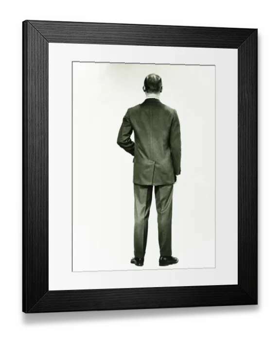 Framed Print : Man in full suit standing in studio, (Rear view), (B&W) Framed Print : Man in full suit standing in studio, (Rear view), (B&W)