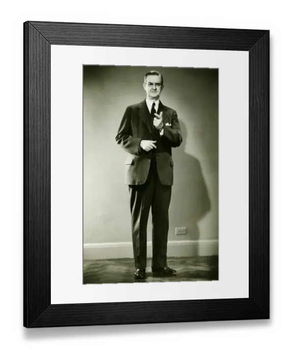 Framed Print : Mature man pointing in studio, (B&W), portrait