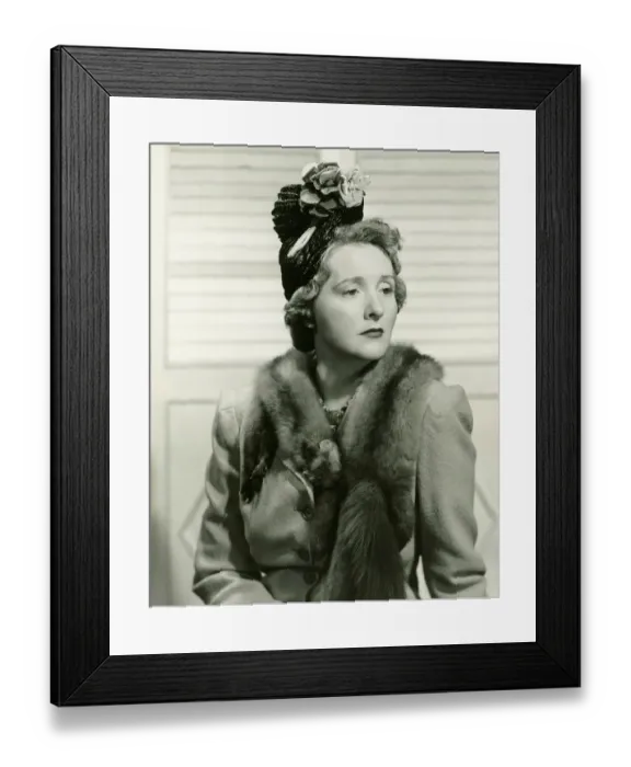 Framed Print : Fashionable woman in hat with artificial flowers posing in studio, (B&W), portrait