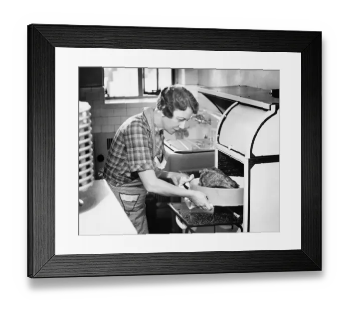 Framed Print : Housewife removing turkey from oven, (B&W) Framed Print : Housewife removing turkey from oven, (B&W)