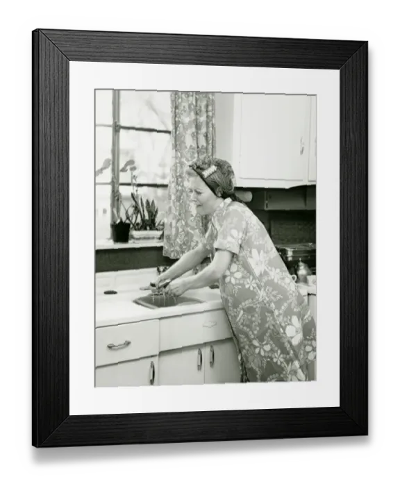 Framed Print : Housewife doing dishes at kitchen sink, (B&W)