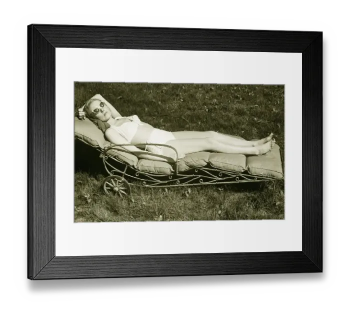 Framed Print : Woman sun tanning on meadow, (B&W), elevated view Framed Print : Woman sun tanning on meadow, (B&W), elevated view