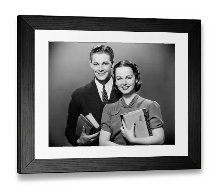 Framed Print : Couple holding books, posing in studio, (B&W), portrait Framed Print : Couple holding books, posing in studio, (B&W), portrait