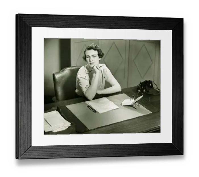 Framed Print : Worrying woman sitting at desk in office, (B&W) Framed Print : Worrying woman sitting at desk in office, (B&W)