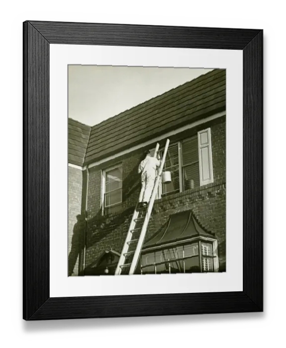 Framed Print : Man on ladder painting shutter (Rear view), (B&W), low angle view