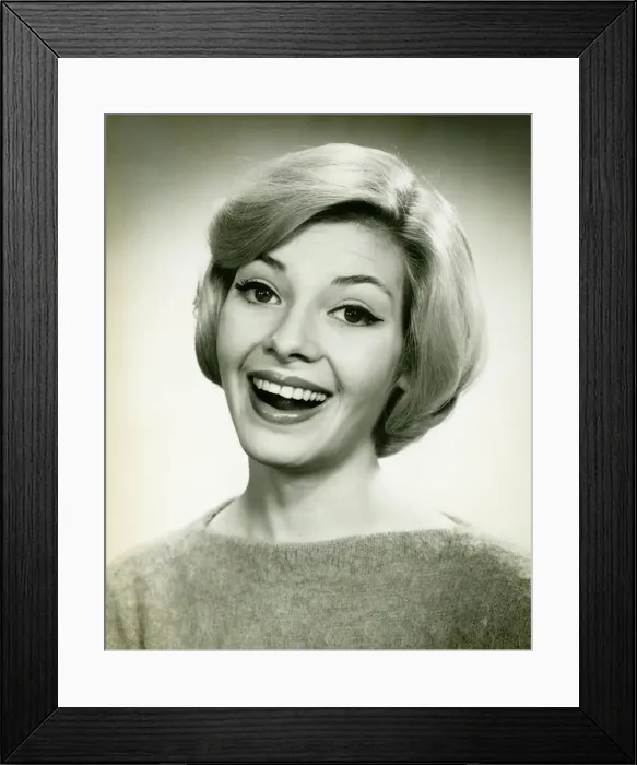 Framed Print : Young woman smiling, posing in studio, (B&W), (Portrait) Framed Print : Young woman smiling, posing in studio, (B&W), (Portrait)