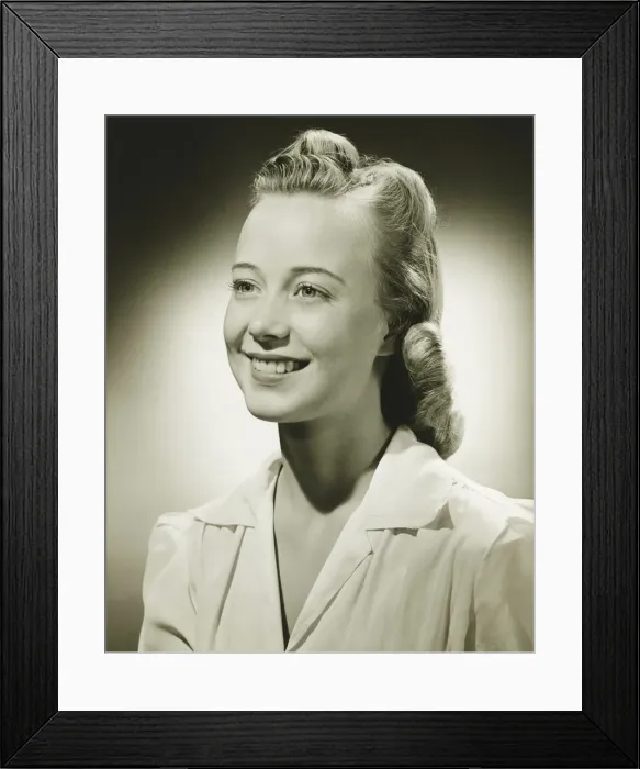 Framed Print : Smiling woman posing in studio, (B&W), portrait Framed Print : Smiling woman posing in studio, (B&W), portrait