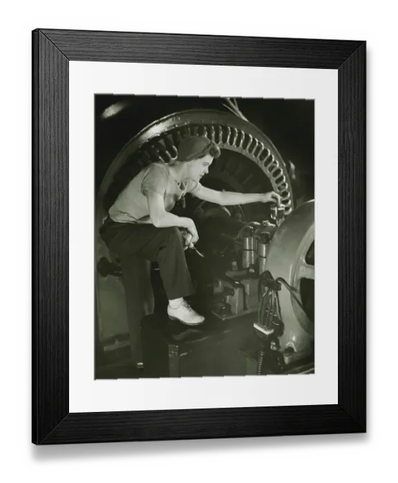 Framed Print : Woman operating machine in factory, (B&W) Framed Print : Woman operating machine in factory, (B&W)